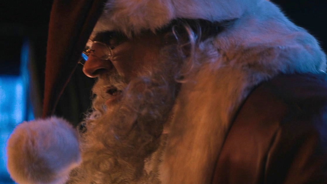 Violent Night: Santa Claus Gets Caught Hiding Behind A Christmas Tree